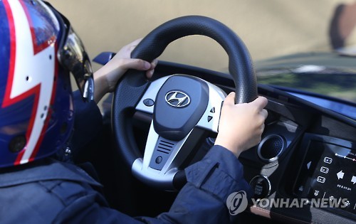 The cars at the playground have an 'auto reset' button which aligns the car with the middle of the track. (Image : Yonhap)