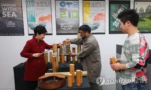 President Park Geun-hye (L) tries out a musical instrument at the new content industry office that opened in Seoul on Dec. 29, 2015. The office is a cluster of venture firms that will be able to receive government consulting services for planning, marketing and managing their content. More than 90 startups are expected to take advantage of the service at the office, which offers working space rent-free for two years. (Image : Yonhap)