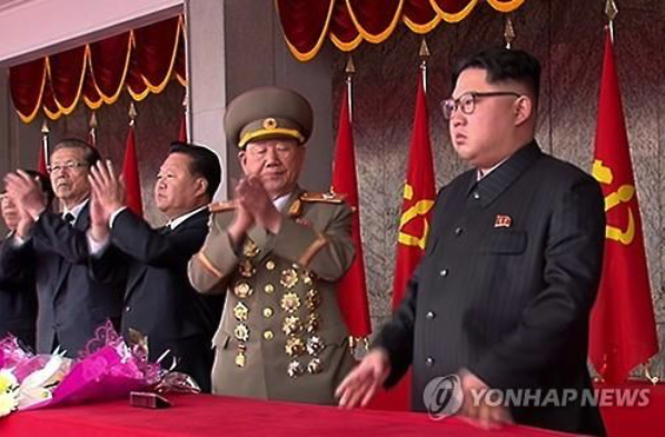 North Korean leader Kim Jong-un (R) reviews the mass celebration event in Pyongyang on May 10. (image: Yonhap)