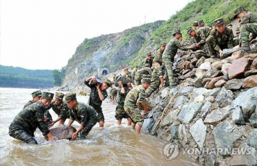 North Korean Students Killed Trying to Recover Portraits of Supreme Leaders from Flood