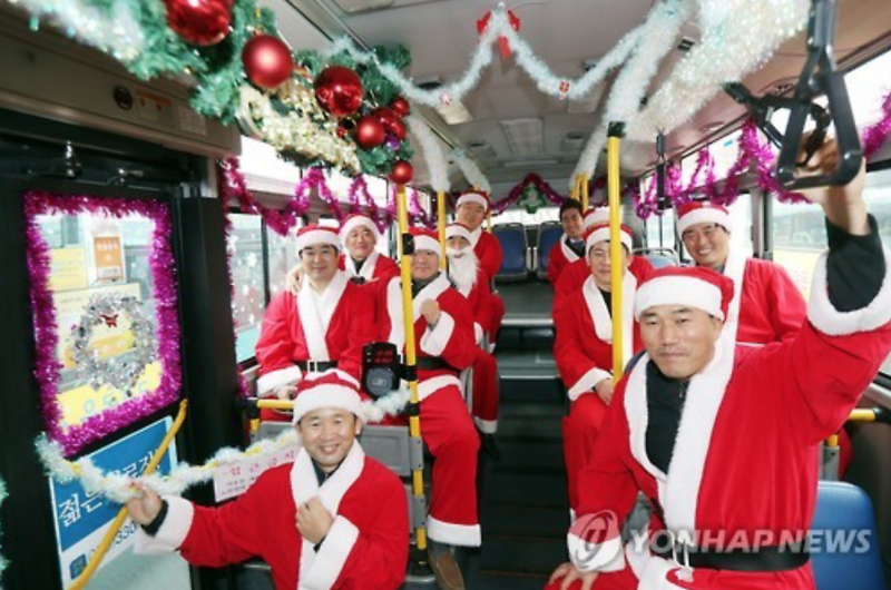 Public Bus Decorated with Mistletoe and Santa Claus Drivers