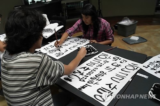 This file photo, dated Oct. 8, 2012, shows students engaging in a contest writing the Korean alphabet, or "hangeul," ahead of an opening ceremony at the Autonomous University of Nayarit in Tepic, the capital of Mexico's Nayarit State, for a King Sejong Institute Korean-language learning facility. (Image: Yonhap)