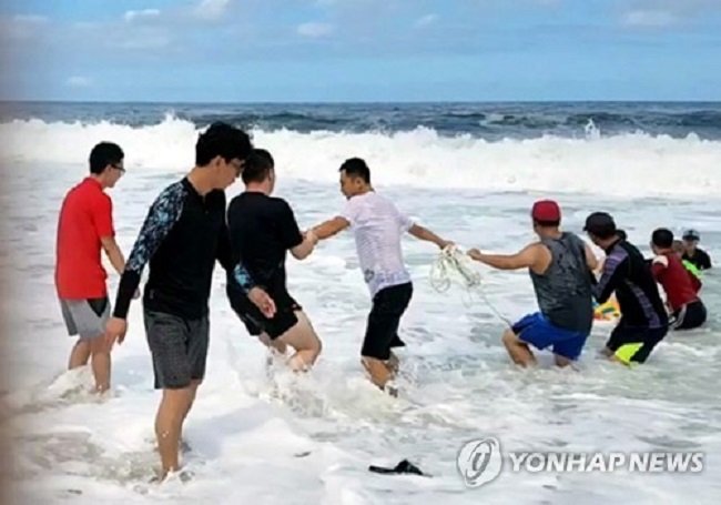The rescued man began to breathe easy moments after being pulled from the water. (Image: Yonhap)