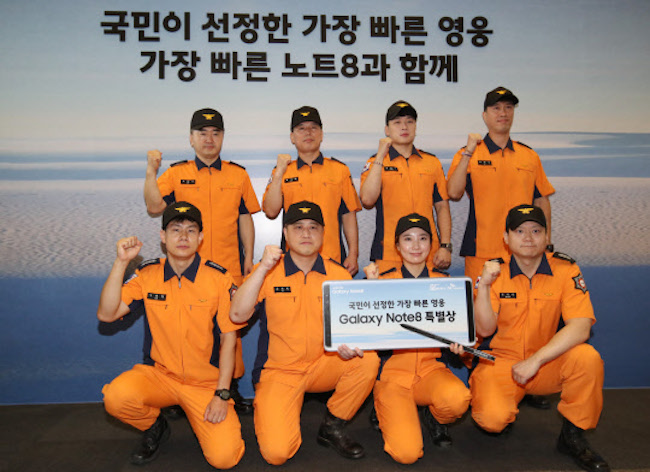 A group of uniform clad firefighters were present at SK Telecom's main office building in Jung District (Jung-gu) at 8 in the morning on September 15. (Image: Yonhap)