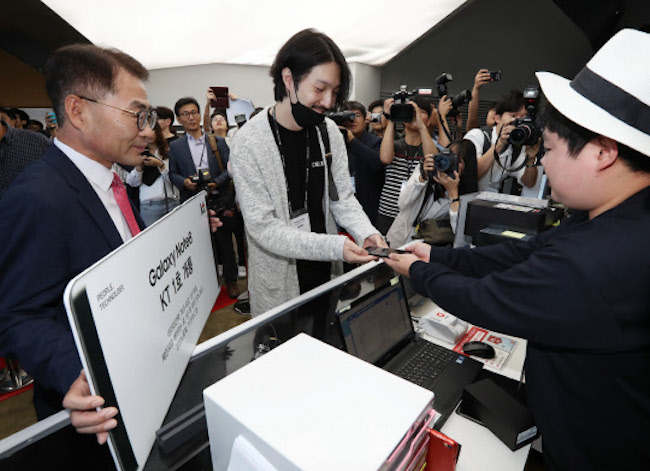 The appearance of celebrities was no doubt a welcome sight to Lim, who had steadfastly maintained the front of the line since 4 p.m., September 12 (KT's launch was also held on September 15). (Image: Yonhap)