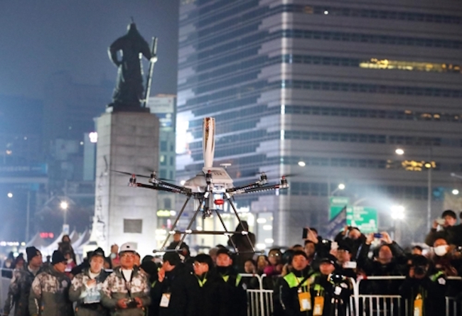 In Two Firsts, Drone Carries Olympic Torch at Night in Seoul City Square