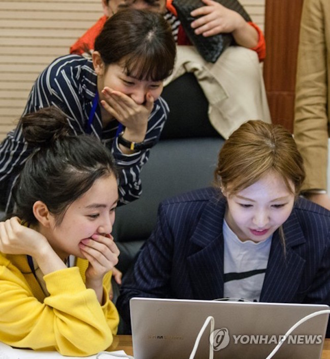 Members of Red Velvet checking out North Korea's internet. (Image: Yonhap)