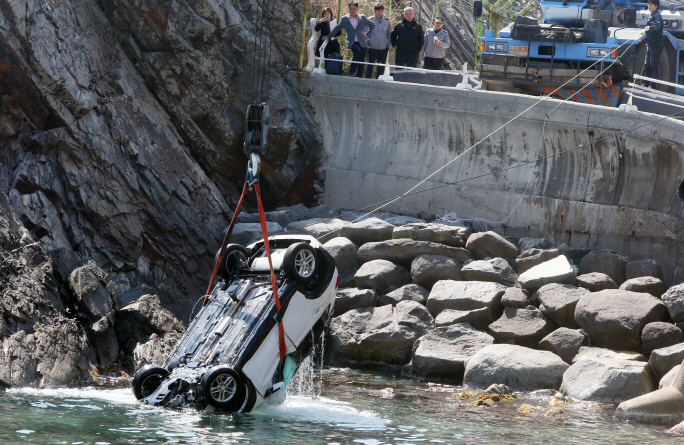 The Coast Guard pulls a white Hyundai Kona out of the water in the eastern coastal city of Gangneung on March 26, 2019, after the car fell into the sea with five people inside. Police said no one survived the crash. (Yonhap)