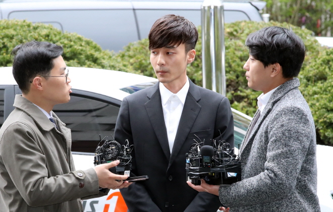 Singer Roy Kim answers a reporter's question as he appears at the Seoul Metropolitan Police Agency on April 10, 2019, for an interrogation over alleged sharing of porn over a mobile chat. (Yonhap)