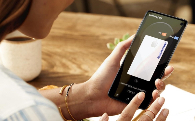 A model demonstrates Samsung Pay in this file photo released by Samsung Electronics.
