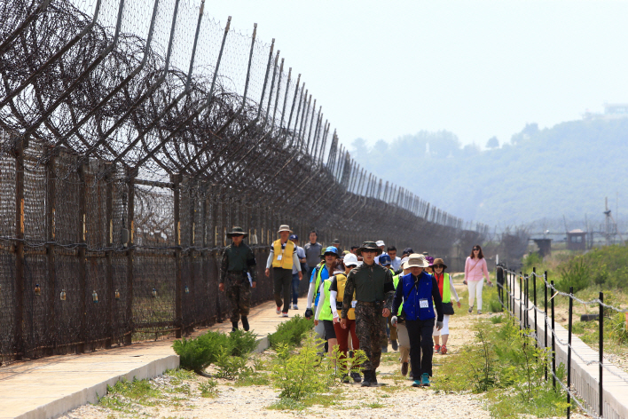 Tourists walk along a trail adjacent to the Demilitarized Zone (DMZ), named the DMZ Peace Trail, in the northeastern border county of Goseong on June 26, 2019, nearly two months after its opening. (Yonhap)