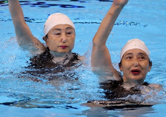 Japan's Makiko Morota and Satomi Nakayama perform during the duet technical event of artistic swimming for people aged 60 through 69 during the FINA World Masters Championships at Yeomju Gymnasium in the southwestern city of Gwangju on Aug. 6, 2019. (Yonhap)