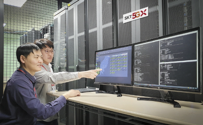 This photo provided by SK Telecom on Jan. 20, 2020, shows the company's researchers testing its 5G network communication.