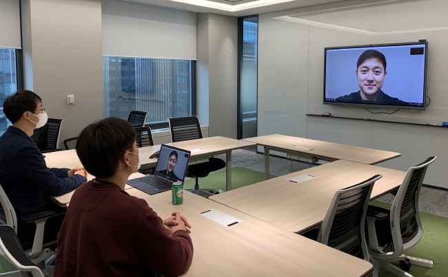 This photo provided by SK Innovation Co. on March 11, 2020, shows company officials testing a video interview system at its office building in Seoul.