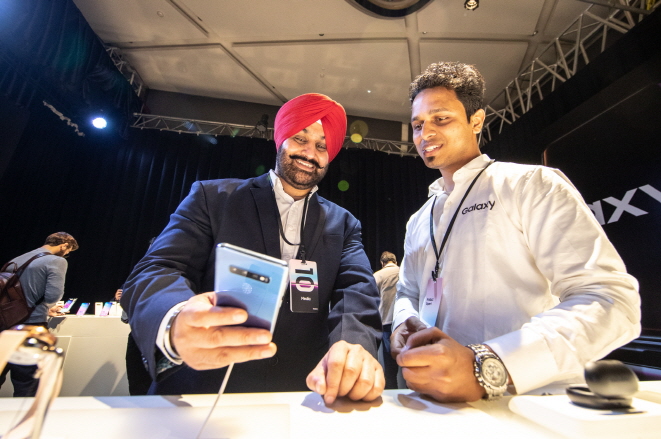 This photo provided by Samsung Electronics Co. shows visitors to a launch event for the Galaxy S10 in New Delhi, India, on March 7, 2019.