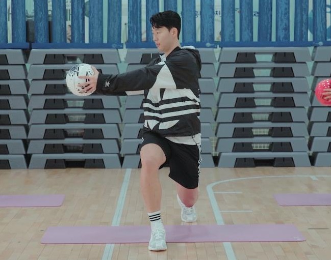 Tottenham Hotspur's South Korean star Son Heung-min demonstrates a stretching exercise using a ball as part of an indoor exercise campaign by the culture ministry amid the coronavirus crisis, in this photo provided by the ministry on April 21, 2020.