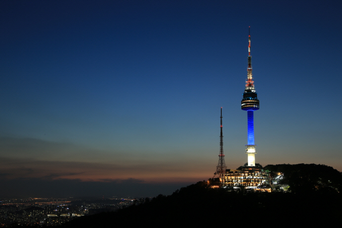N Seoul Tower is lit up with blue light in this photo provided by Seoul City Hall on April 16, 2020.