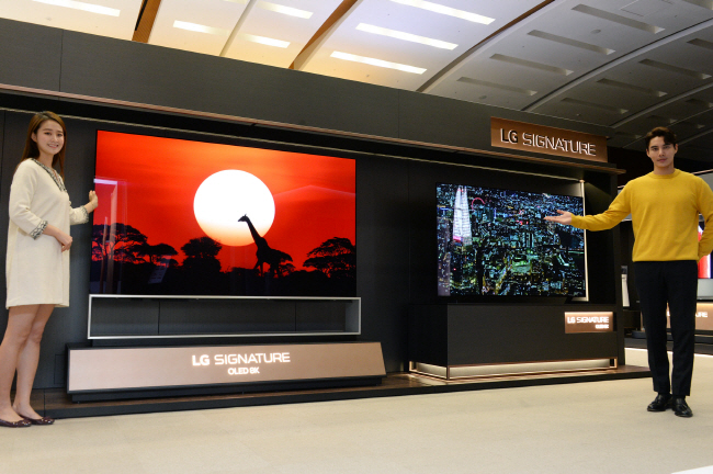 This photo provided by LG Electronics Inc. on Jan. 3, 2020, shows models introducing the company's Signature OLED 8K TVs.