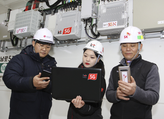 This photo provided by KT Corp. on Jan. 17, 2020, shows engineers from LG Uplus Corp. (L), KT (C) and SK Telecom Co. checking their 5G networks at a subway station in Gwangju.