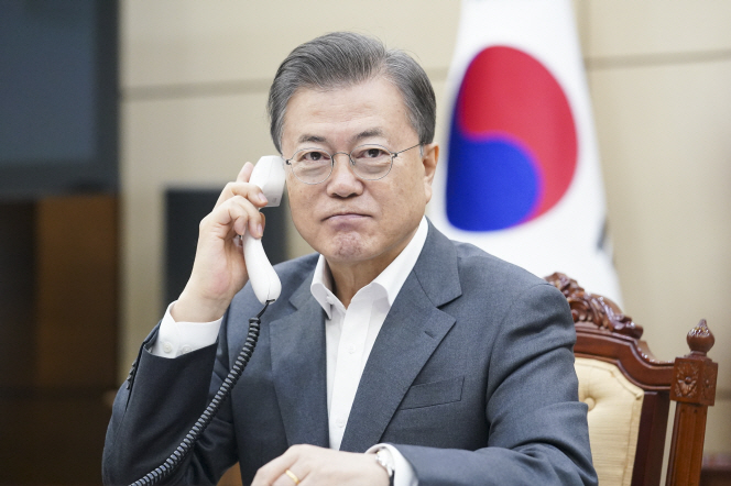 This photo, provided by Cheong Wa Dae, shows President Moon Jae-in having a telephone conservation with Microsoft founder Bill Gates over the new coronavirus on April 10, 2020.