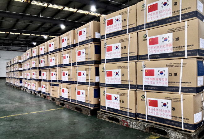 This photo, provided by the Chinese Embassy in South Korea, shows boxes of surgical masks stacked up at Incheon International Airport, west of Seoul, after they arrived from Shanghai as part of Beijing's assistance with coronavirus equipment to Seoul, on March 23, 2020.