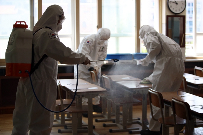 In this photo, taken on May 1, 2020, military medical soldiers disinfect a classroom at an elementary school in Daegu. (Yonhap)