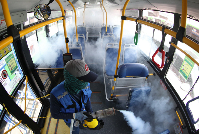 A health worker disinfects a bus at a terminal in eastern Seoul on May 7, 2020. (Yonhap)