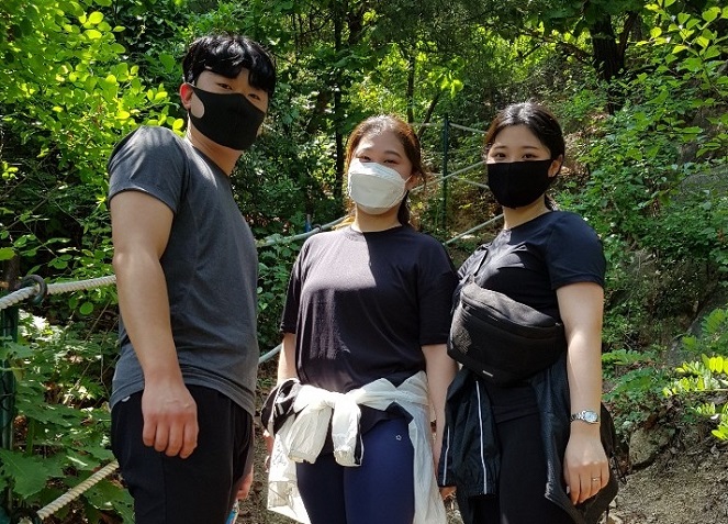 In this photo taken on June 14, 2020, Kim Ga-in (C), her younger sister Do-hee and Ga-in's boyfriend Han Seung-je pose for Yonhap News Agency at Mount Inwang in northern Seoul. (Yonhap)