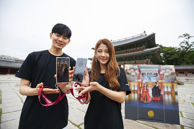 Models showcase SK Telecom Co.'s augmented reality application that digitally recreates the royal Changdeok Palace in central Seoul on July 27, 2020, in this photo provided by SK Telecom.