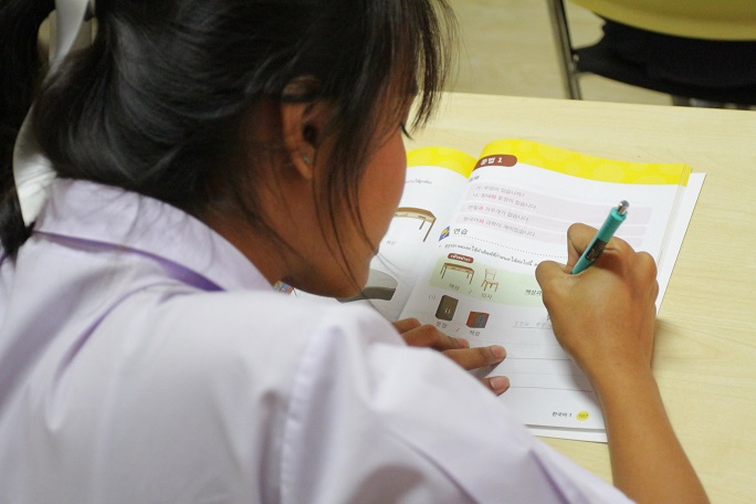 This undated file photo provided by the Ministry of Education shows a Thai student learning Korean.