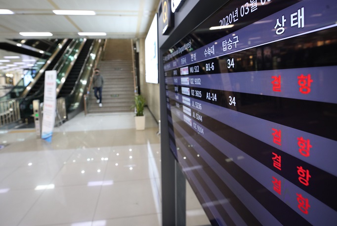 A departure board at Gimpo International Airport in western Seoul shows that flights on international routes have been canceled on March 9, 2020. (Yonhap)