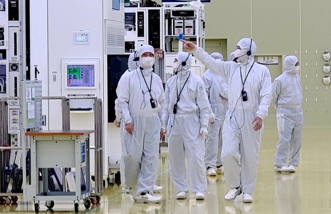 In this photo provided by Samsung Electronics Co. on June 30, 2020, Samsung Electronics Vice Chairman Lee Jae-yong (R) inspects a production facility of Semes Co., a Samsung Group affiliate that makes semiconductor and display manufacturing equipment, in Cheonan, some 90 kilometers south of Seoul. 