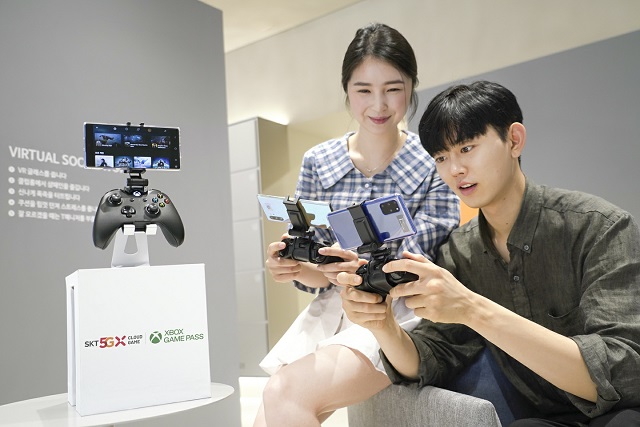 Models play games on Microsoft Corp.'s cloud gaming service, in this photo provided by SK Telecom Co. on Aug. 5, 2020.