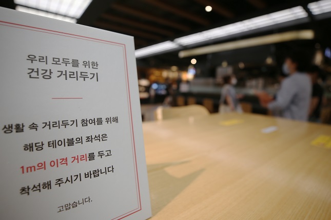 This file photo shows a signboard calling for social distancing at Shinsegae Department Store in the southwestern city of Gwangju. (Yonhap)