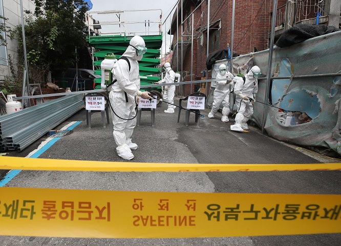 Public officials disinfect a church in Seoul's Seongbuk Ward on Aug. 14, 2020, following the detection of a cluster of new coronavirus infections at the church. (Yonhap)