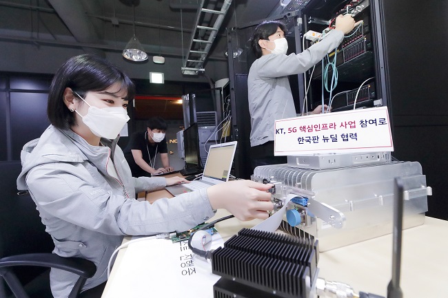 KT Corp. researchers inspect 5G equipment at the telecom operator's offices in southern Seoul, in this photo provided by the company on Sept. 16, 2020.