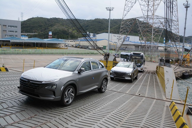 This photo taken Sept. 28, 2020, and provided by Hyundai Motor shows two Nexo hydrogen fuel cell electric vehicles and two hydrogen Elec City buses being loaded onto a ship for export to Saudi Aramco at the carmaker's port in Ulsan, 414 kilometers southeast of Seoul. 