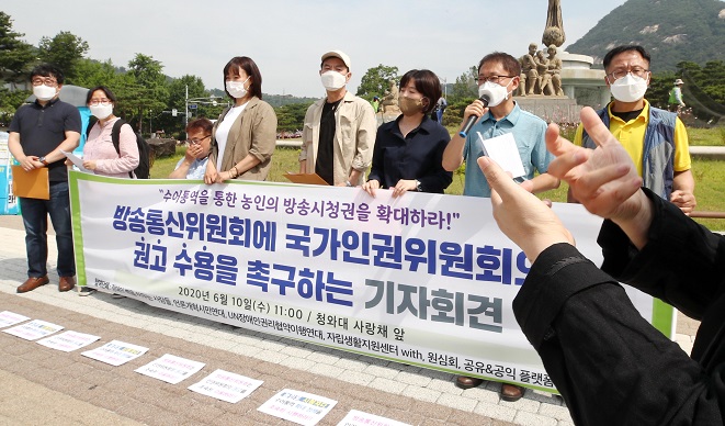In this file photo taken on June 10, 2020, activists stage a rally to urge South Korea's terrestrial broadcasters to accept the National Human Rights Commission's recommendation to provide a sign-language interpretation service on main news programs, in front of the presidential office of Cheong Wa Dae in Seoul. (Yonhap)