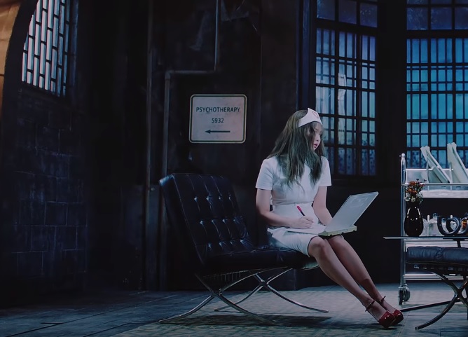 This screenshot from K-pop group BLACKPINK's latest music video "Lovesick Girls" shows member Jennie wearing a hair cap, a white dress and red high heels. 