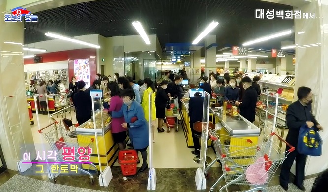 In this image taken from a video aired by North Korea's propaganda website DPRK Today, North Korean people wearing masks shop at Taesong Department Store in Pyongyang on May 13, 2020. (Yonhap)