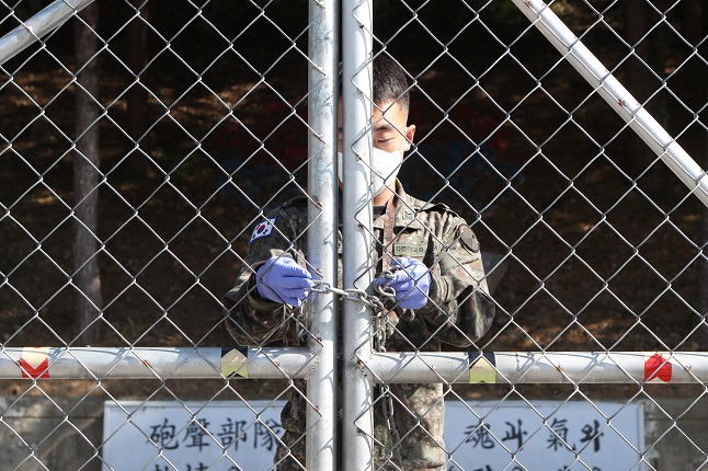 A soldier locks the gate of a military base in Pocheon, north of Seoul, on Oct. 5, 2020. (Yonhap)