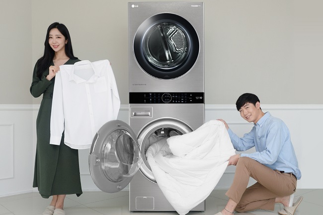 This photo provided by LG Electronics Inc. on Oct. 14, 2020, shows models promoting LG's new WashTower model that comes with a large washer and dryer.