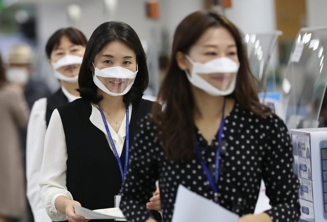 Employees wear transparent masks amid the coronavirus pandemic at a ward office in the southwestern city of Gwangju on Oct. 12, 2020, to help deaf visitors communicate better with them as they can lip read. (Yonhap)