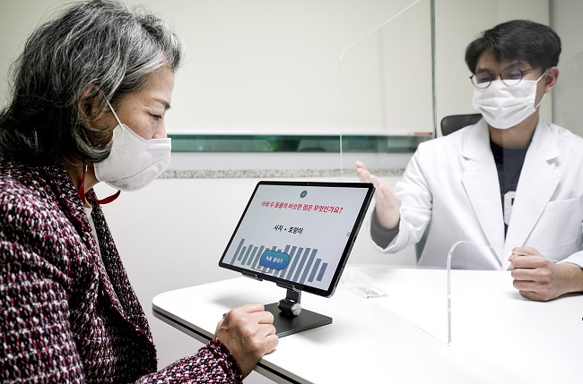 A patient uses SK Telecom Co.'s artificial intelligence program that can assess dementia by analyzing the patients' speech, in this photo provided by the company on Nov. 2, 2020.