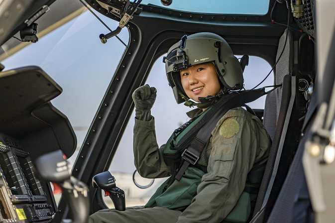 This photo provided by the Marines on Nov. 1, 2020, shows Cho Sang-ah posing for a photo on a Marineon utility chopper.