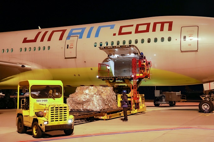 Jin Air employees load cargo onto a B777-200ER at Incheon International Airport, west of Seoul, on Oct. 31, 2020, in the photo provided by the low-cost carrier.