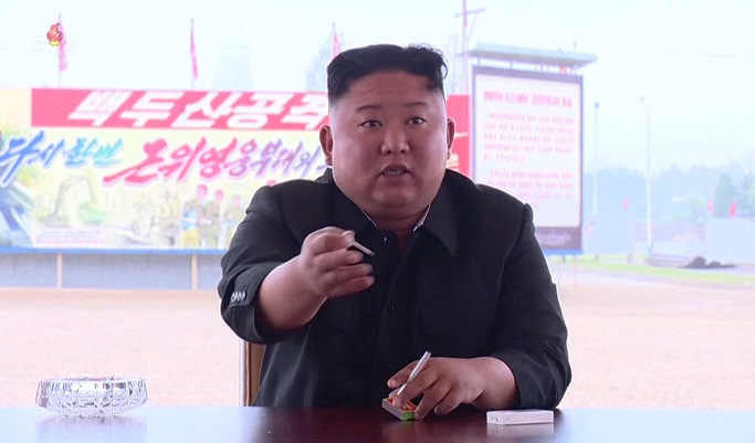 North Korea's top leader Kim Jong-un is seen holding a cigarette in this photo captured from the North's Korean Central TV on July. 20, 2020. (Yonhap)