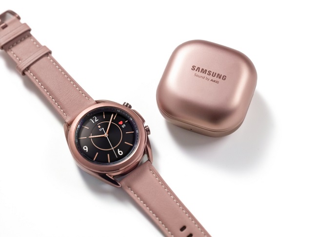 This photo provided by Samsung Electronics Co. shows the company's Galaxy Watch3 smartwatch and the case of Galaxy Buds Live wireless earbuds.