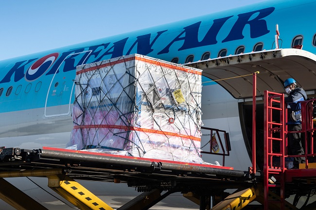A Korean Air passenger jet receives a container of a COVID-19 vaccine ingredient at Incheon International Airport, west of Seoul, to head to Amsterdam, in this photo provided by the airline on Dec. 9, 2020.