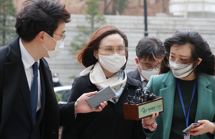 Chung Kyung-sim (C), the wife of former Justice Minister Cho Kuk, arrives at the Seoul Central District Court in southern Seoul on Dec. 23, 2020, to attend her sentencing trial. (Yonhap)